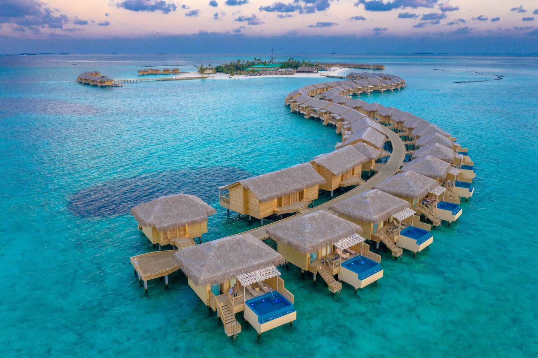 Overwater villas at sunset in the Maldives